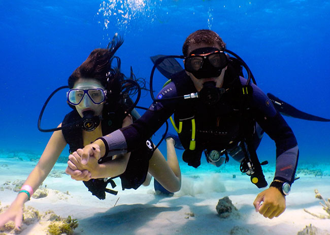 Ruth and her boyfriend holding hands during their first Cozumel discover scuba tour.